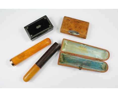 A Smoker's Lot. This lot includes a Continental amber and gold collared cigarette holder, stamped Ed Simeon, Teplitz Marienba