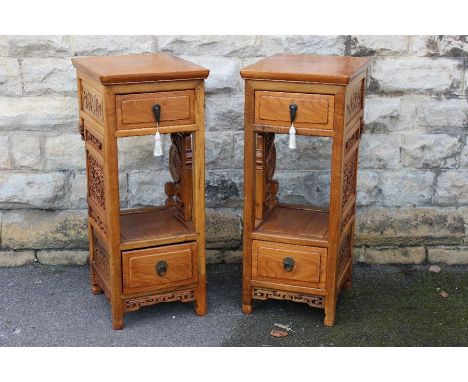 Two Chinese Hardwood Torchere; each cabinet having a single drawer, decorative carvings to skirt and shelf, straight feet, ap