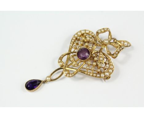 An Edwardian 15ct Gold Amethyst and Seed Pearl Brooch/Pendant, the pendant having central amethyst approx 7mm with a tear sha
