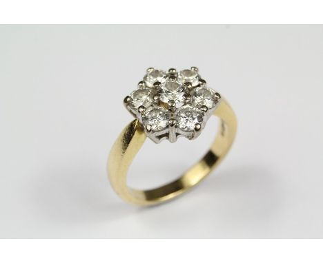 An 18ct Yellow Gold Diamond Ring, the floral ring set with a center diamond of approx 33 pts and surrounded by six&nbsp; diam