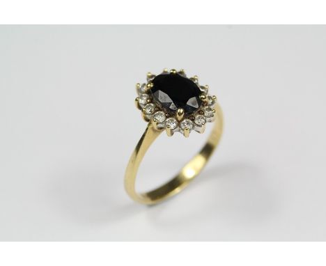 Lady's 18ct Gold Sapphire and Diamond Ring, the oval sapphire approx 8 x 6mm, surrounded by approx 28 pts of dias, size J+, a