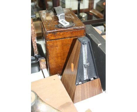 AN OAK CASED PIGEON CLOCK, no makers markings, together with a metronome (2)