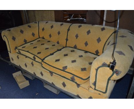 A REUPHOLSTERED CHESTERFIELD SOFA, with Georgian style tapered block legs with brass and ceramic casters