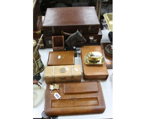 A TAN LEATHER DESK STAND, together with two small brown cases, a Victorian brass match holder with enamel silhoutte to the li