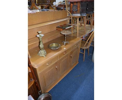 A LIGHT OAK EXTENDING DINING TABLE, seven spindle back chairs and a matching sideboard with raised shelf back above three sho