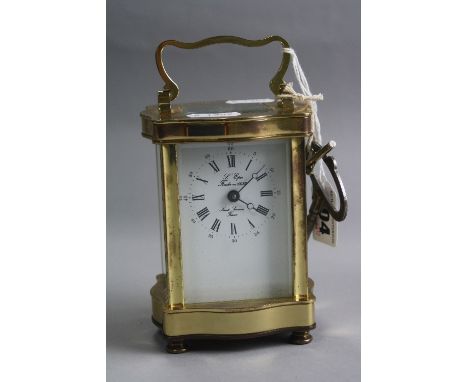 A BRASS CARRIAGE CLOCK, serpentine design, 'L'Epee France', approximate height 11.5cm (key)