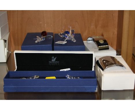 TWO BOXED SWAROVSKI CRYSTAL TULIPS AND A BOXED STAND, together with nine miniature Swarvovski crystal tulips (in two boxes) a
