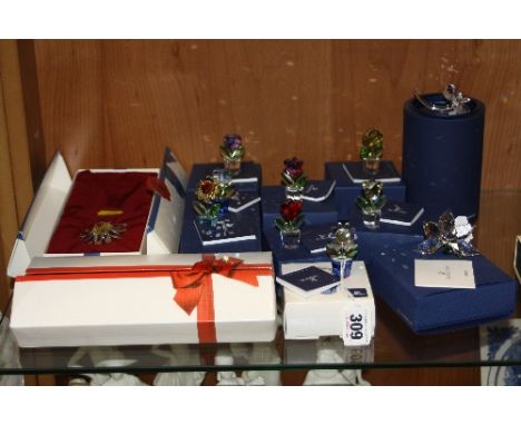 EIGHT BOXED SWAROVSKI FLOWER POTS, together with four other Swarovski boxed flowers (one box is missing a flower)