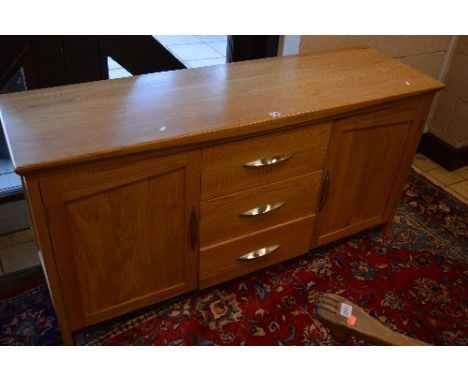 A MODERN LIGHT OAK SIDEBOARD WITH THREE CENTRAL DRAWERS, approximate size width 150cm x height 73cm x depth 45cm