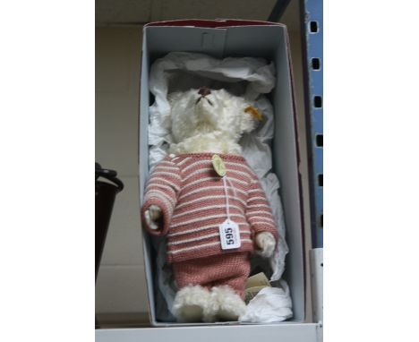 A MODERN STEIFF 1907 REPLICA CLASSIC MOHAIR TEDDY BEAR, (027567), pink woollen suit and cap, approximate height 37cm, in unas