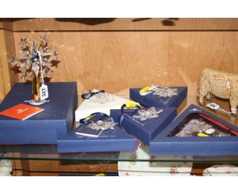 SIX BOXED SWAROVSKI CRYSTAL SNOWFLAKE CHRISTMAS TREE DECORATIONS, to include tree topper, 1999 (white box), 2002, 2004 (one f