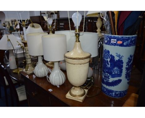 A VICTORIAN WARE BLUE AND WHITE UMBRELLA STAND, with contents, ten various table lamps, one standard lamp, etc (13)