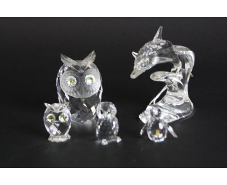 FIVE BOXED SWAROVSKI FIGURES, to include Dolphin (slight chips to fins), large Owl (chip to ear), two smaller owls and pengui
