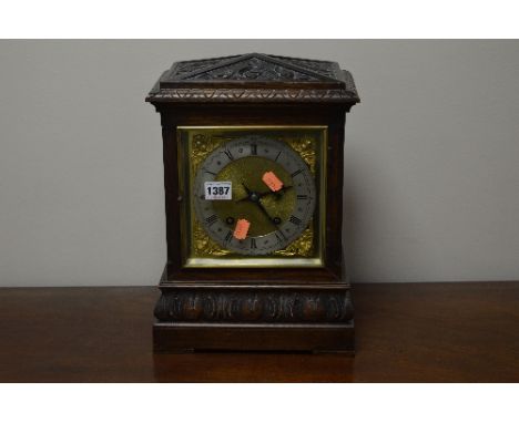A 20TH CENTURY CARVED OAK BRACKET CLOCK, gilt metal face, Roman numerals and foliate carved detail (pendulum) 