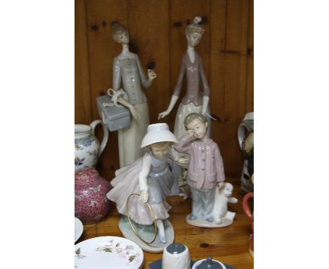 TWO LLADRO FIGURINES, lady with dog and parasol (missing finger) and lady with present (missing parasol), together with two N