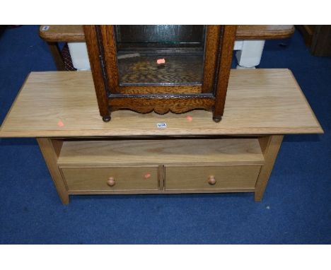 A LIGHT OAK TV STAND, with a single drawer