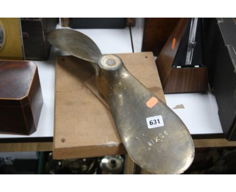 A BRASS SHIPS PROPELLER, mounted on a wooden plinth, stamped 20'' x 15'', some pitting and wear