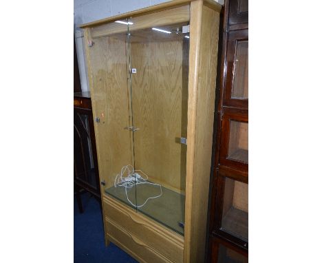 AN ERCOL ASH GLAZED TWO DOOR DISPLAY CABINET, with removable glass shelves above two long drawers, approximate size width 93c