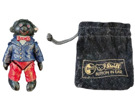 Steiff Pewter Jointed Golly in Original Bag, 2 inch tall. Good condition. All autographs come with a Certificate of Authentic