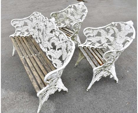 A late 19th century white painted cast aluminium three piece fern back garden suite comprising bench and two chairs, in the m
