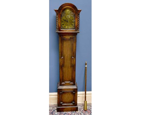 An early 20th century oak cased longcase clock of small proportions, the arch shaped hood enclosing the brass face set with c