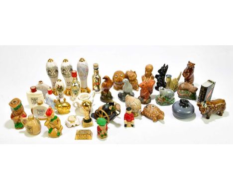 A collection of alcohol miniatures contained in novelty and ceramic flasks.