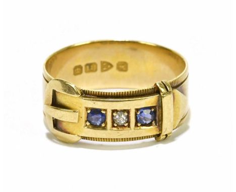 An Edwardian yellow gold buckle ring set with central diamond flanked by two sapphires, Chester 1901, 4.7g.Condition Report: 