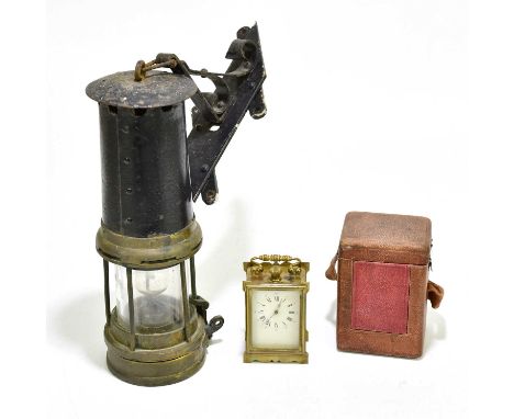 An early 20th century French brass cased crown wind carriage clock, the dial set with Arabic and Roman numerals, and leather 