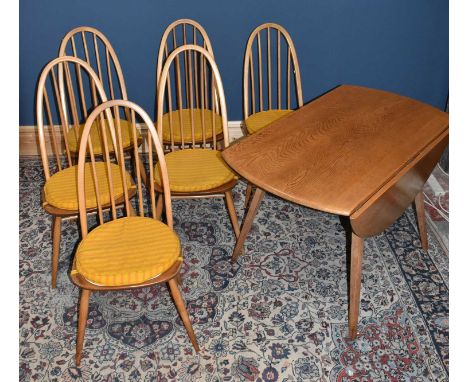 ERCOL; a light elm drop-leaf dining table, width 112cm, together with six spindle back dining chairs on column supports (7).C