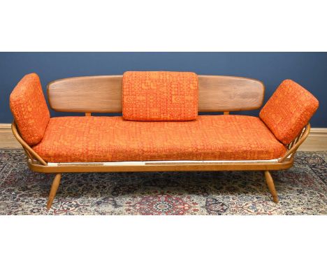 ERCOL; a light elm and beech daybed on turned column legs, width 195cm.Condition Report: The slats have snapped and are missi