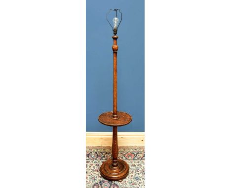 An oak turned standard lamp, height approx 152cm.