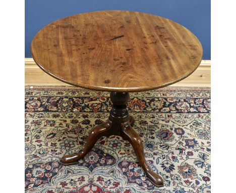 A George III mahogany tripod tilt-top occasional table with one piece top above baluster ring turned central column to three 