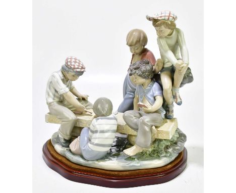 NAO: a figure group of children playing cards, height 35cm.Condition Report: Minor chips and surface wear throughout.