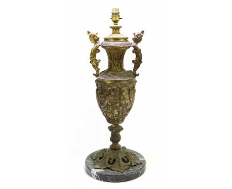A large decorative gilt twin handled lamp raised on circular veined marble base, height including fitment 64cm.