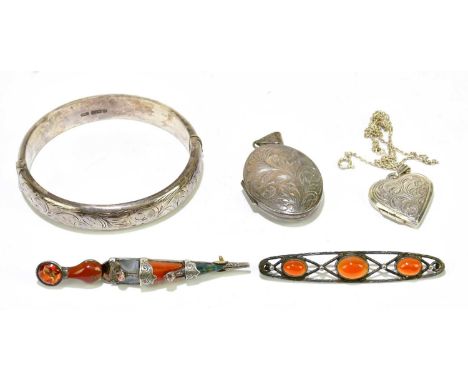 A Scottish hardstone dagger brooch, a further brooch, also a hallmarked silver bangle, and two lockets (5)