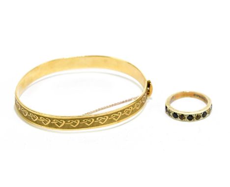 A 9ct yellow gold bangle with chased decoration of hearts, approx. 14.5g, with a 9ct yellow gold dress ring, approx. size P, 