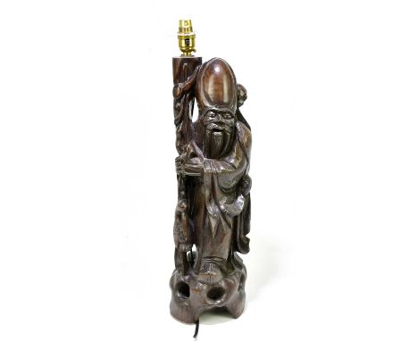 A Japanese carved hardwood lamp modelled as a sage, on pierced rockwork base, height 54cm.Condition Report: The height given 