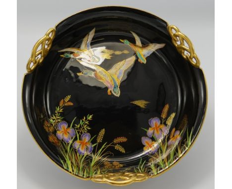 Carltonware fruit bowl decorated with enamelled flying mallard ducks: On black ground, diameter 25cm.