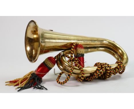 A military brass bugle with multicoloured tassles: