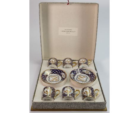 Boxed Bernardaud Limoges cobalt blue and gilt glazed coffee cans and saucers: Each with gilded laurel leaf &amp; bird decorat