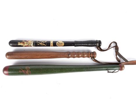 A Victorian truncheon, painted green and red with gold stag crest, 56cms long; another with VR cypher under crown, 45cms; and