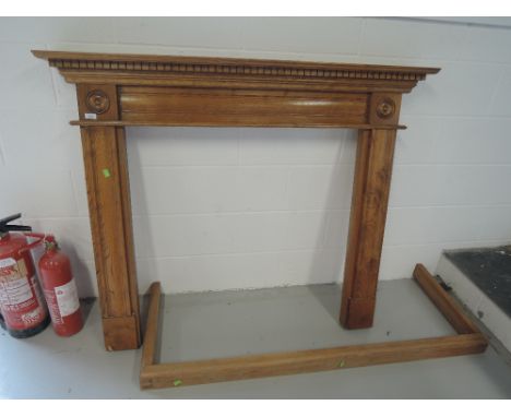 A modern golden oak fire surround