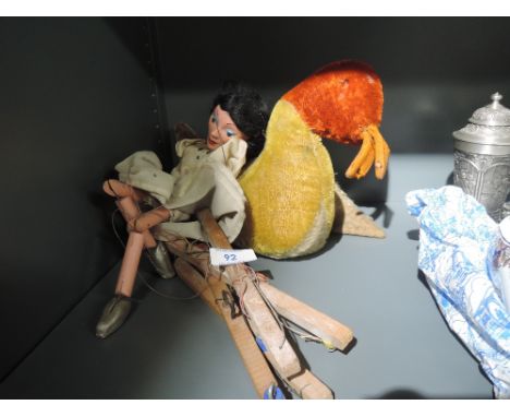 A vintage Steiff style soft toy modelled as a duck and a Pelham style puppet
