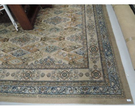 A vintage patterned carpet square having floral and lozenge design