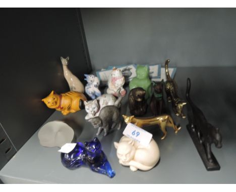 A selection of cat figures and figurines in a mix of mediums glass ceramic etc