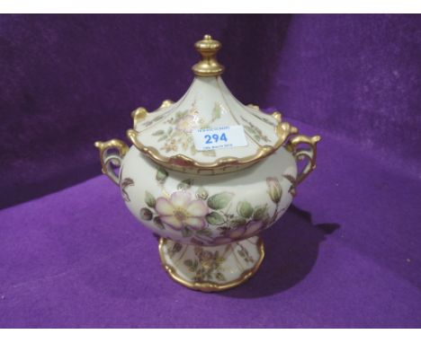 A vintage ceramic lidded urn with twin handle design 