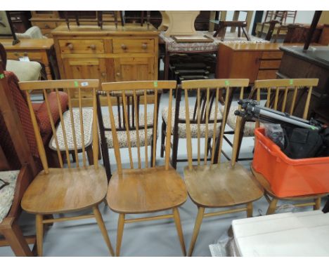 A set of vintage Ercol dining chairs of comb back design