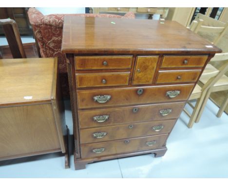 A walnut wood TV cabinet disguised as period style chest of drawers