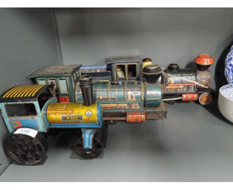 Two Modern Toys (Japan) tin plate trains and a similar tractor