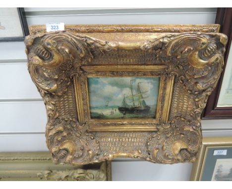 An ornate plaster and gilt effect frame with period print